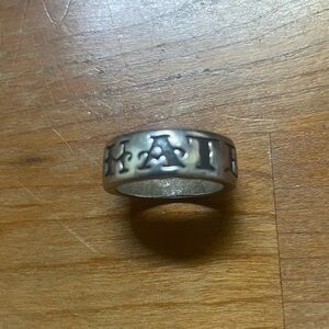 Chunky silver ring with engraved lettering “hate”